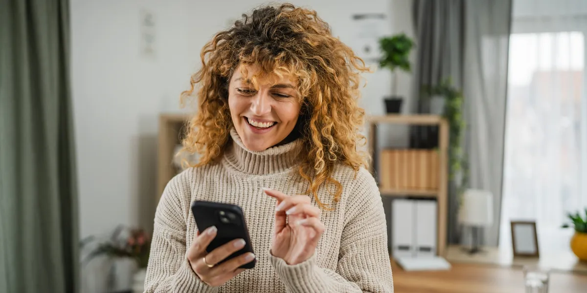 Person working with phone and laptop